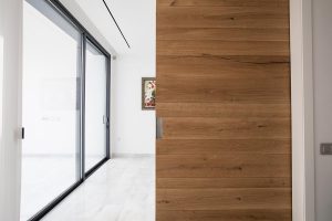 Puerta corredera de grandes dimensiones con lamas de roble natural